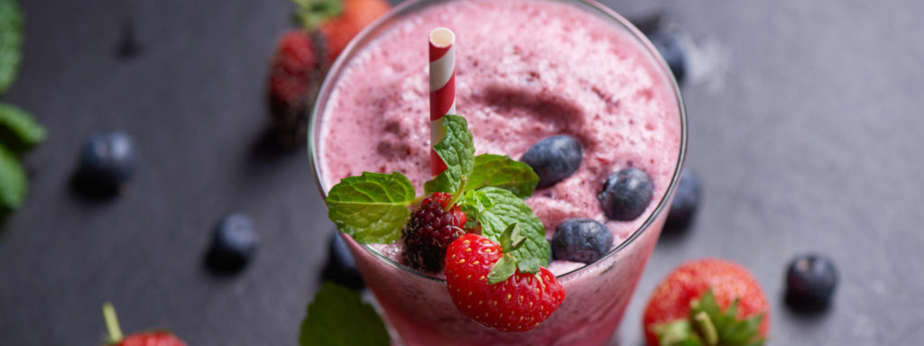 Delicious strawberry, mulberry and blueberry smoothie garnished